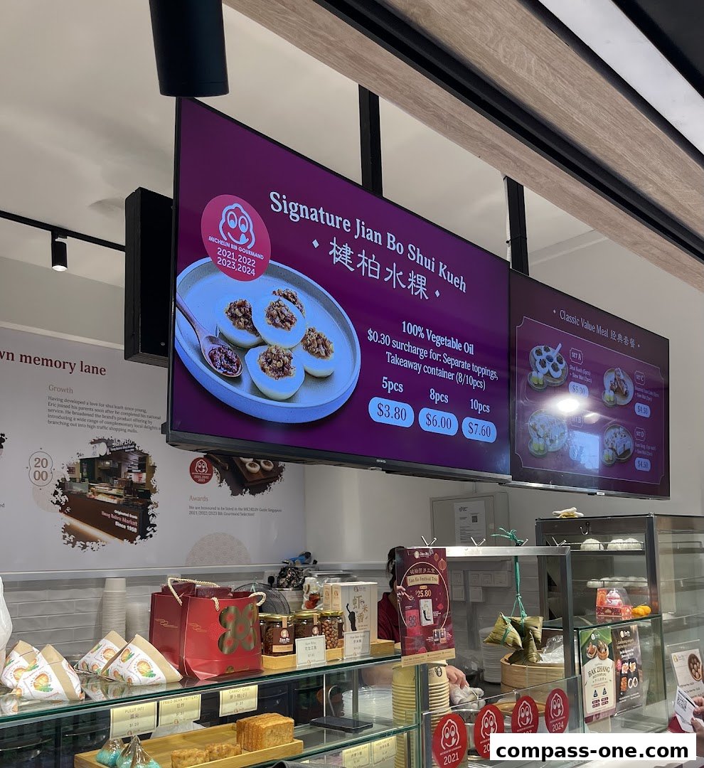 Digital menu boards displaying signature Jian Bo Shui Kueh and classic value meals.