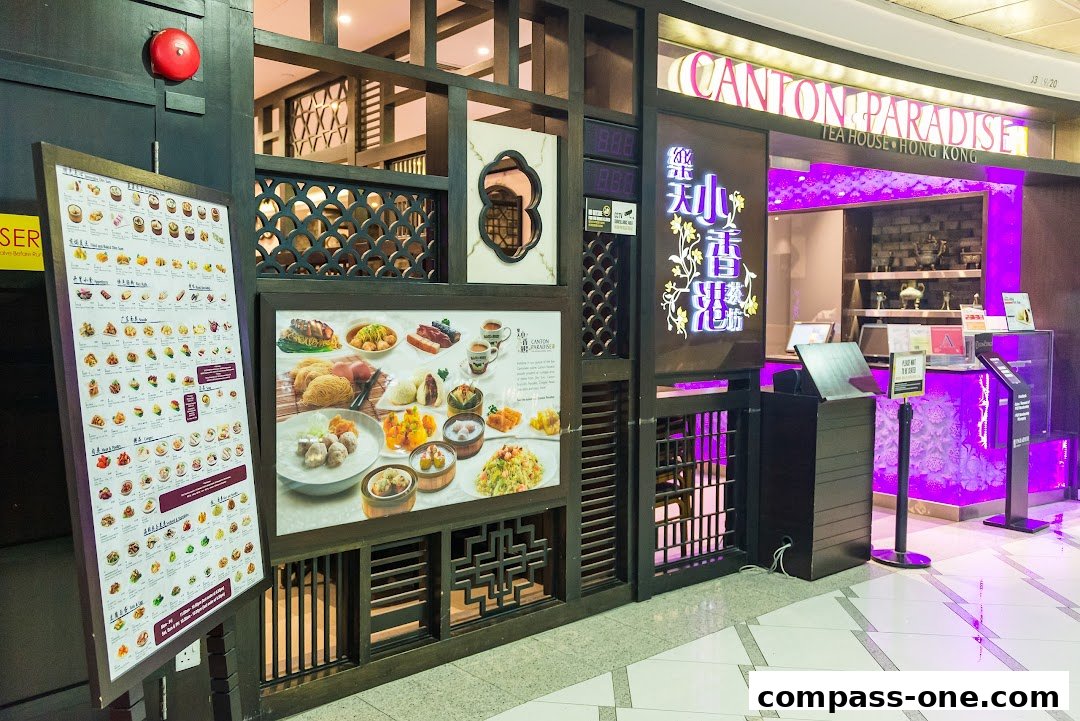 The exterior of Canton Paradise restaurant with a menu board and a display of popular dishes.