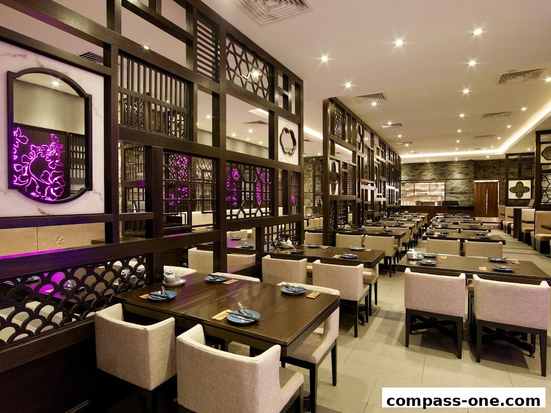 Interior view of a spacious Chinese restaurant with elegant wooden partitions and comfortable seating.