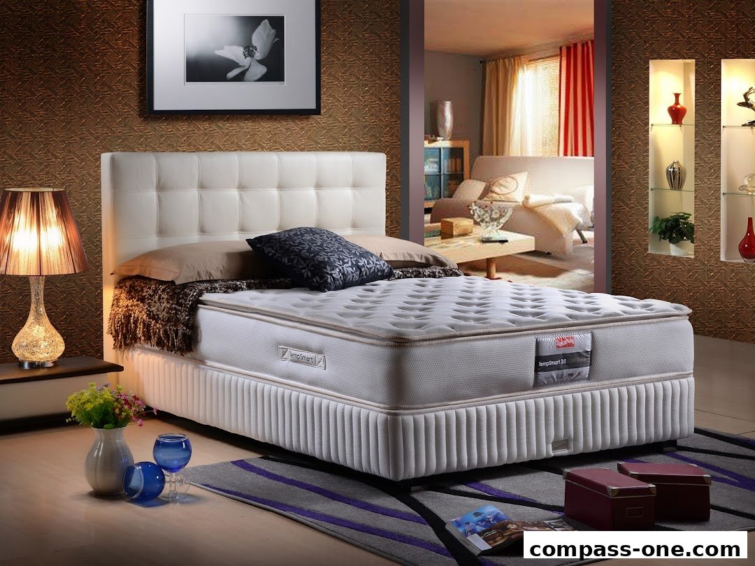 A luxurious bed with a white headboard and a comfortable mattress is displayed.