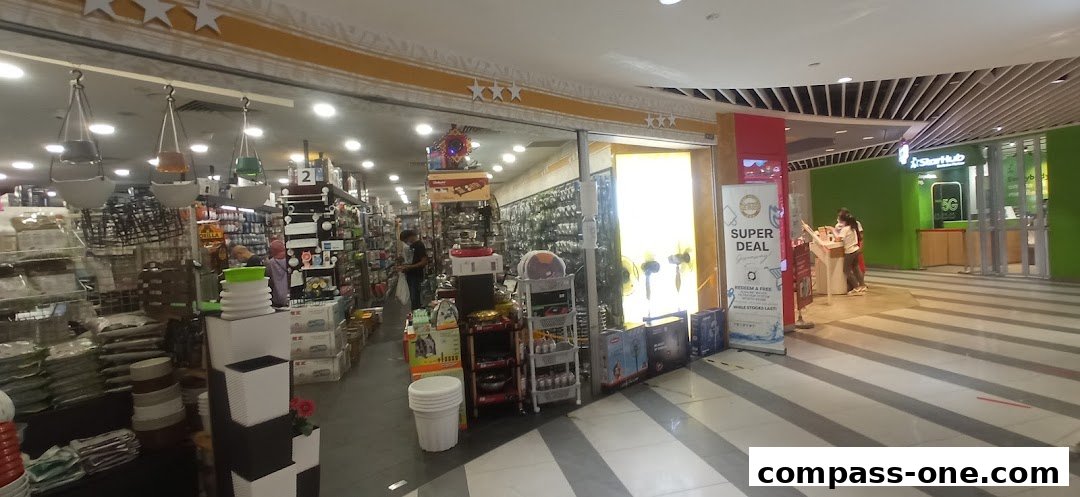 Interior view of Kim Able Household store showcasing various home goods and a 'Super Deal' promotion.