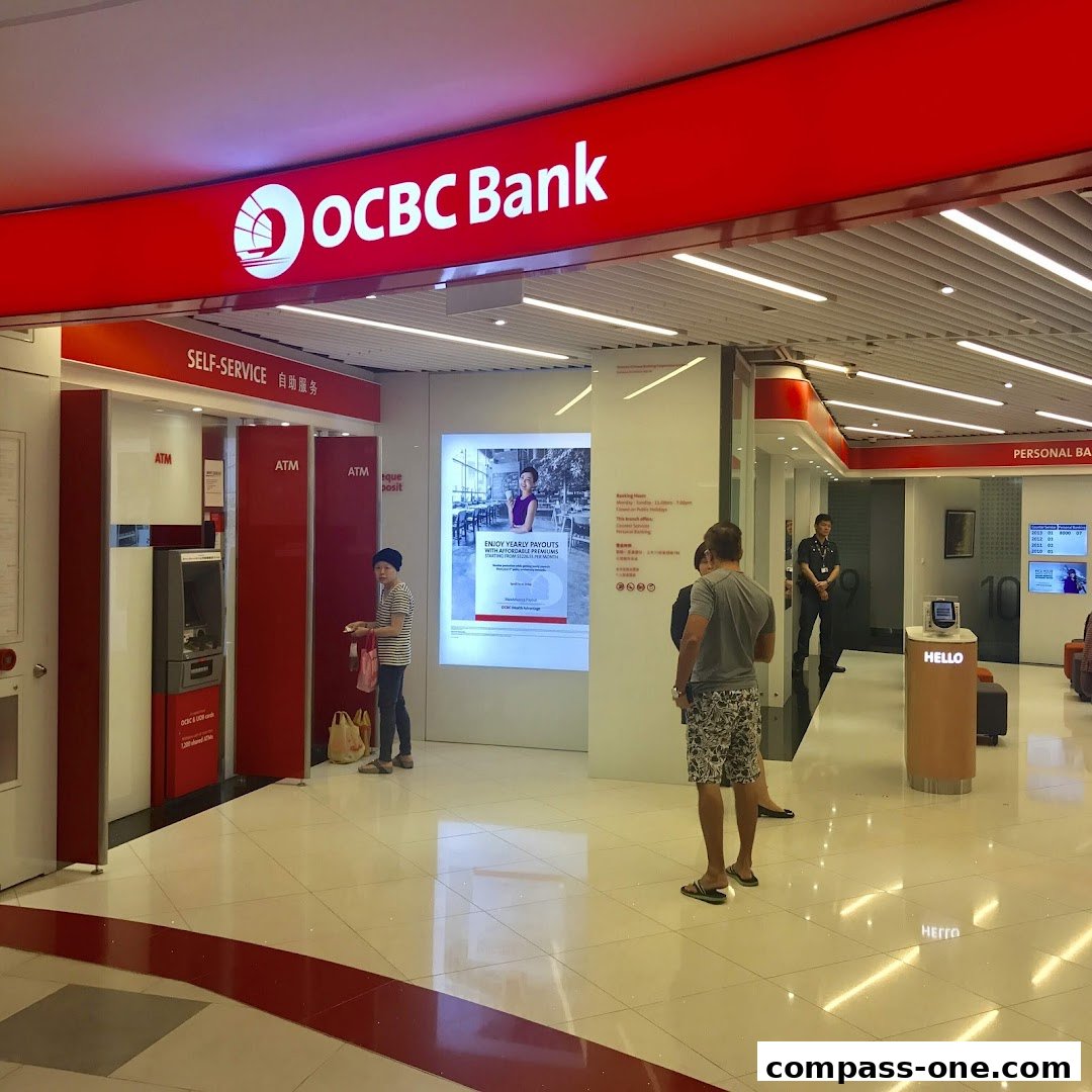 The entrance of an OCBC Bank branch with ATMs and people waiting.