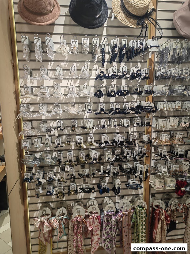 A wall display of various hair accessories and hats, featuring claw clips and scarves.