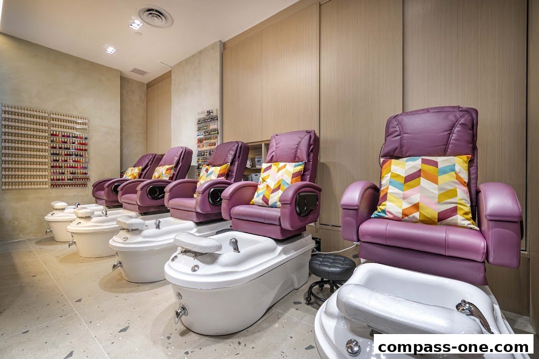 A row of luxurious purple pedicure chairs with colorful pillows and foot baths.