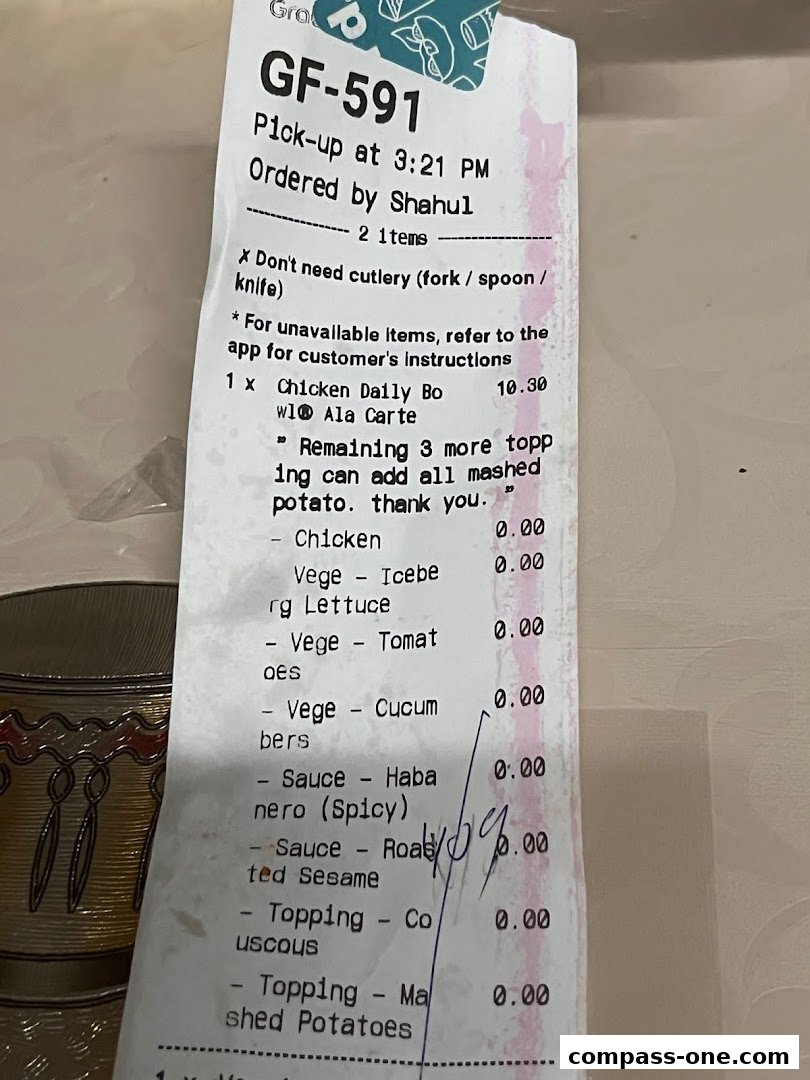 A receipt from Stuffd showing a chicken order with various toppings and sauces.