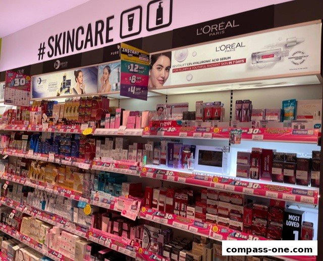 Shelves stocked with various skincare products, featuring L'Oreal and other brands.