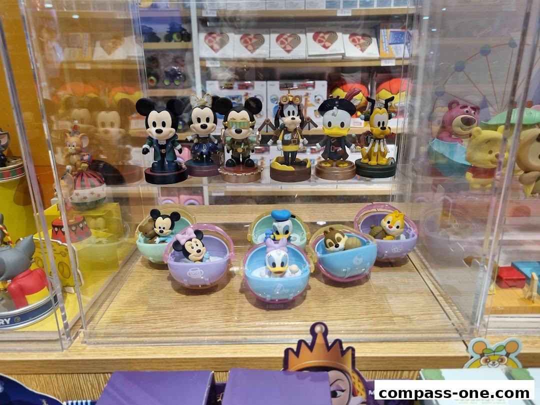 Display of Disney character figurines in clear cases, featuring Mickey Mouse and friends.