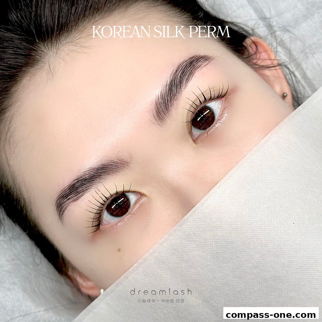 Close-up of a woman's eyes showcasing perfectly permed lashes and groomed eyebrows.