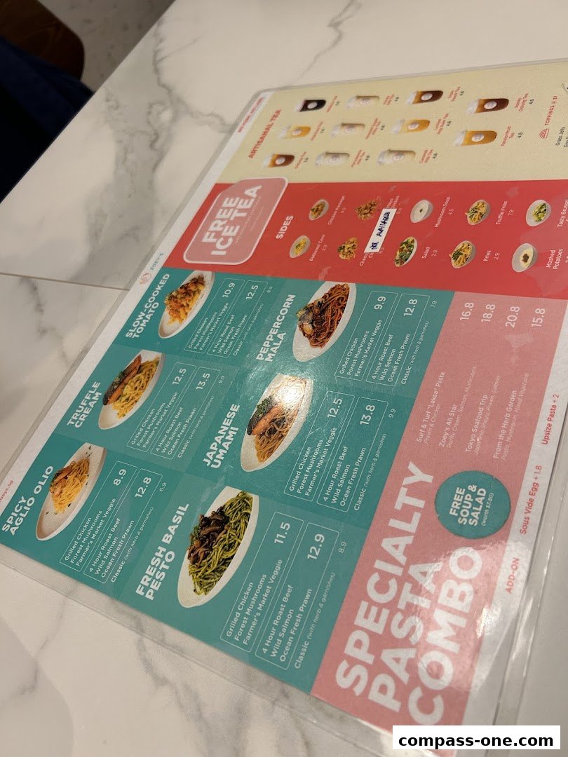 A menu from Zoeys featuring pasta dishes, sides, and artisanal teas with prices.