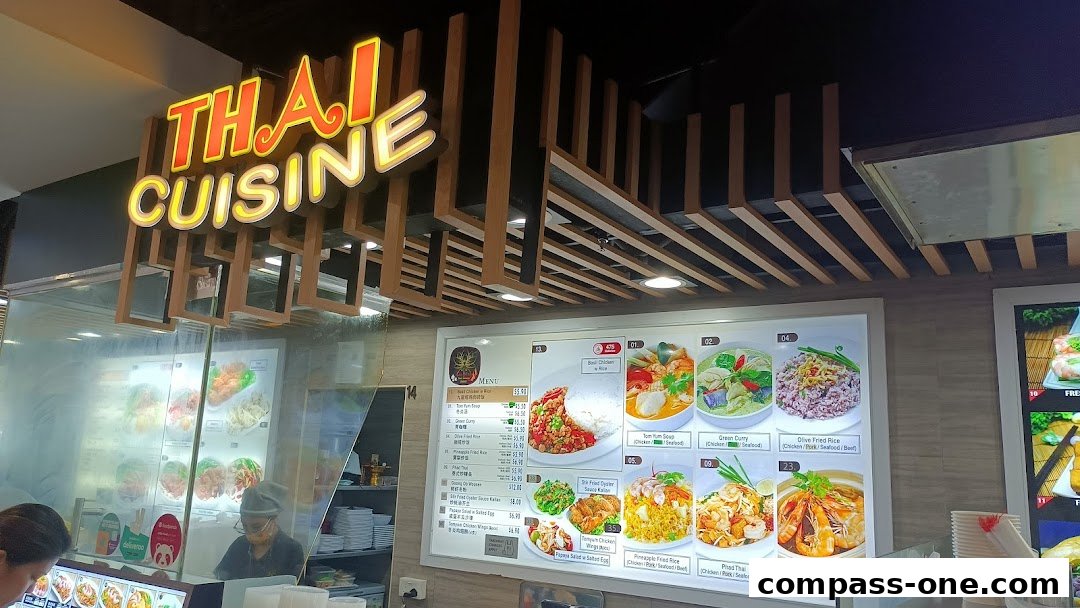 A brightly lit menu board displaying various Thai dishes with enticing images and prices.