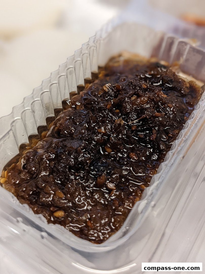 A close-up of a delicious Shui Kueh dish in a clear plastic container.