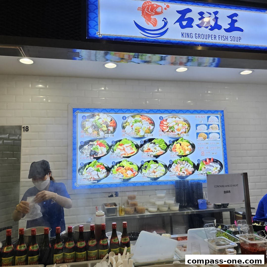 A food stall displaying a menu of King Grouper Fish Soup with various dishes and prices.