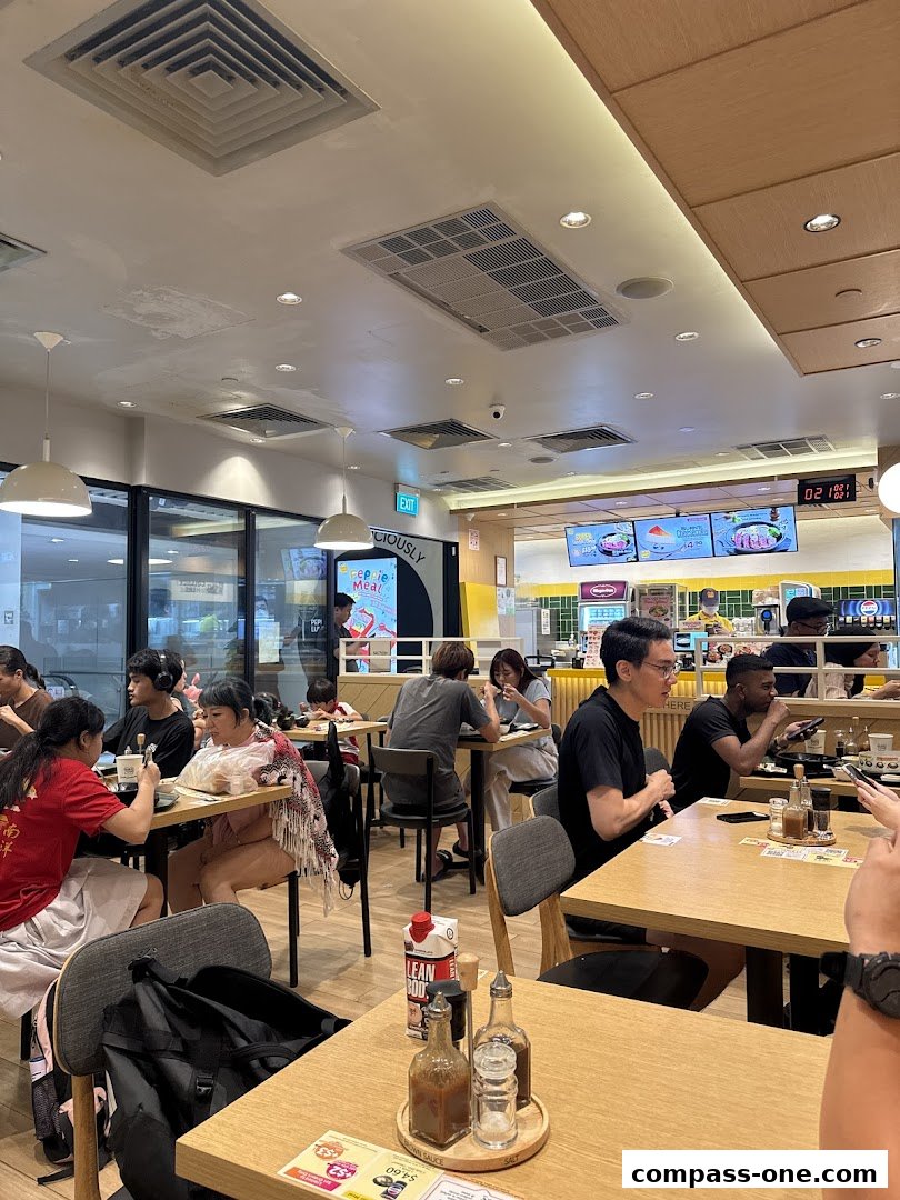 Diners enjoying meals at Pepper Lunch restaurant, with a lively atmosphere and bright interior.