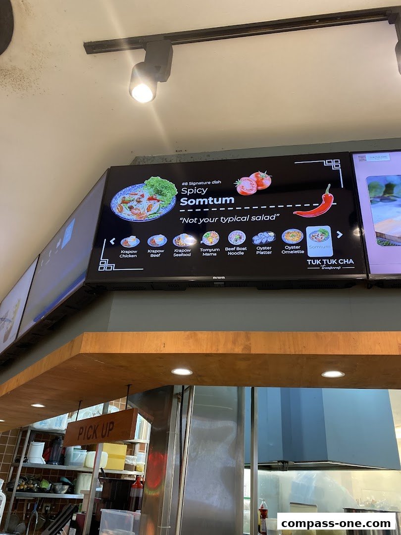 A digital menu board displaying Thai dishes, highlighting Spicy Somtum.