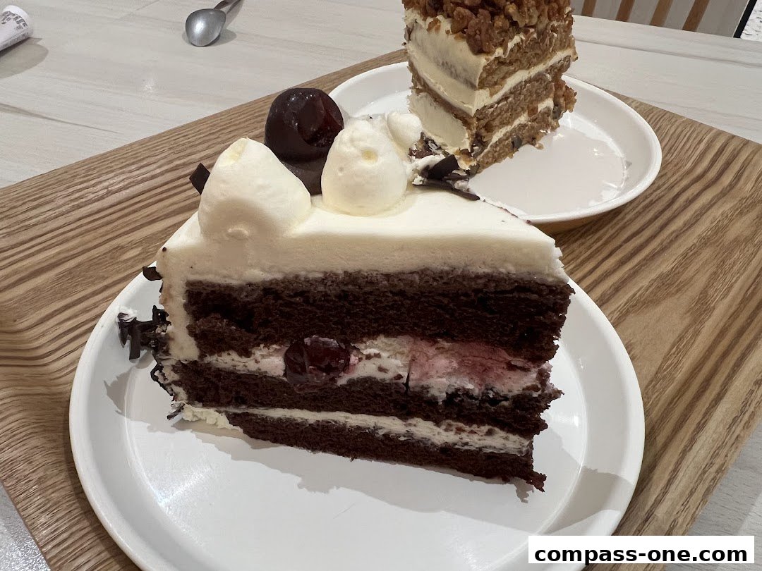 Two slices of delicious cake, one chocolate and one carrot cake, served on white plates.