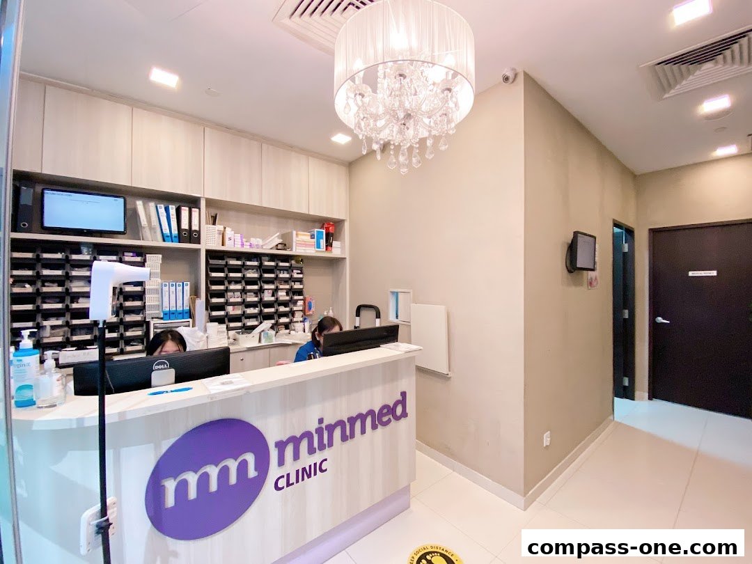 The reception area of Minmed Clinic Sengkang with staff at the counter and a chandelier.