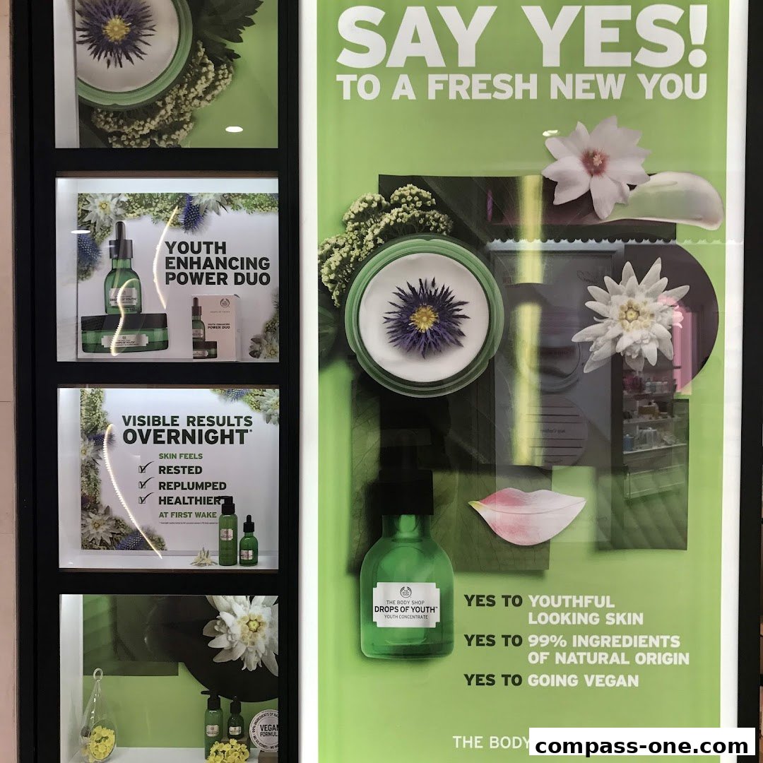 The Body Shop storefront window display featuring skincare products and promotional text.