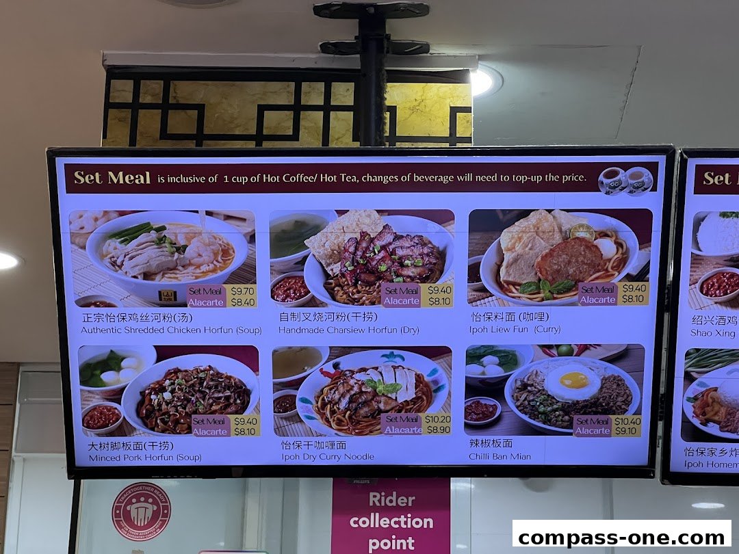 A digital menu board displaying various Ipoh delicacies with images and prices.