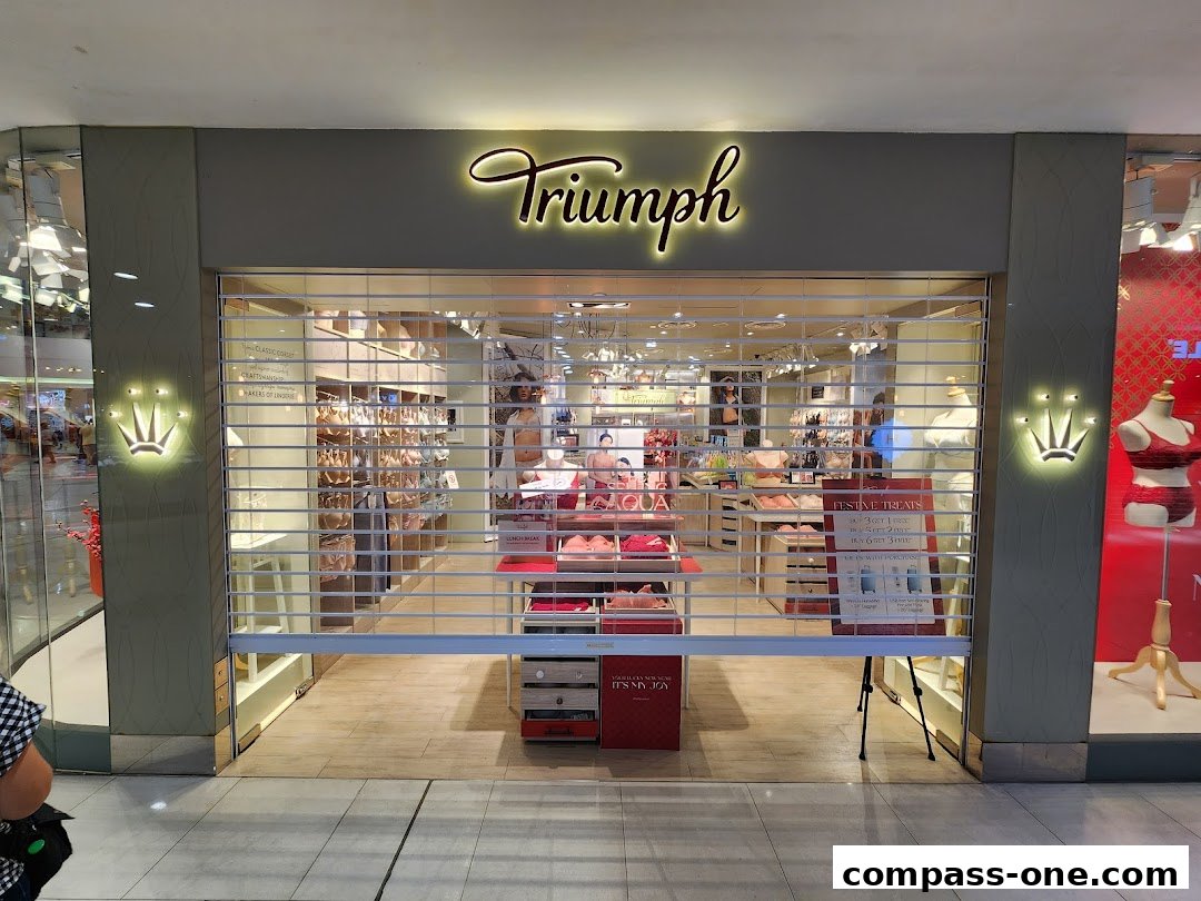 The Triumph lingerie shop entrance with its roller shutter partially down.