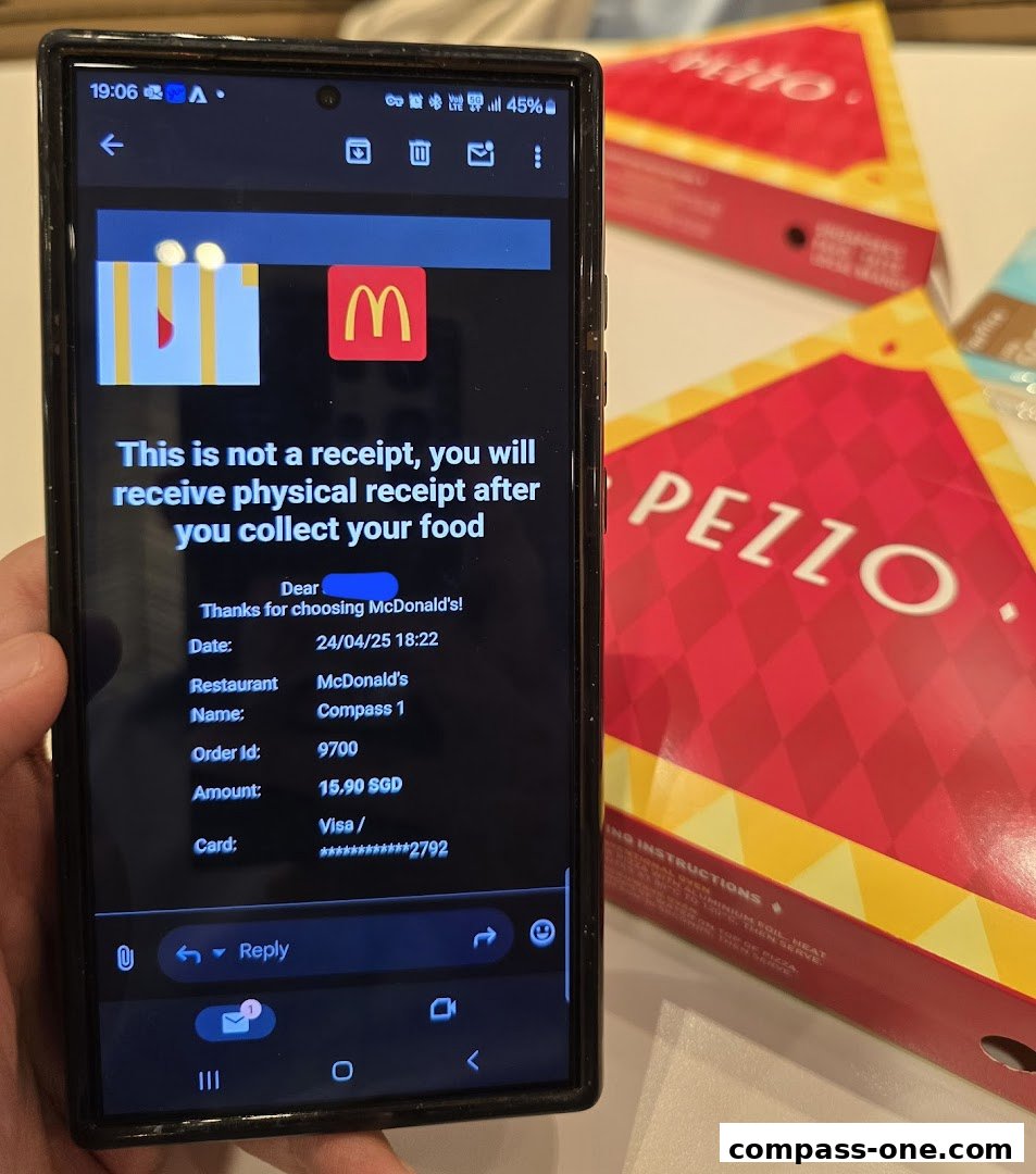 A phone displays a McDonald's order confirmation next to Pezzo pizza boxes.