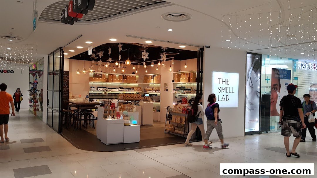 The Smell Lab shop entrance with products displayed inside and people walking by.