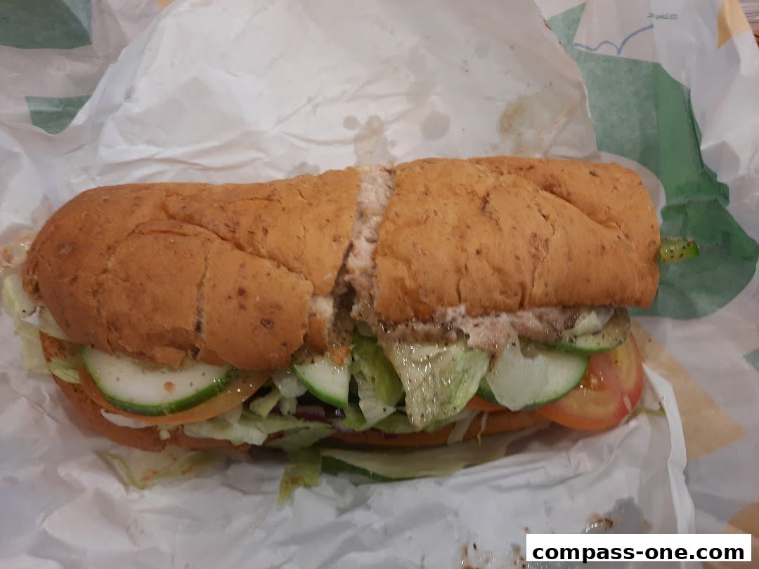 A delicious Subway sandwich with fresh vegetables on whole wheat bread.