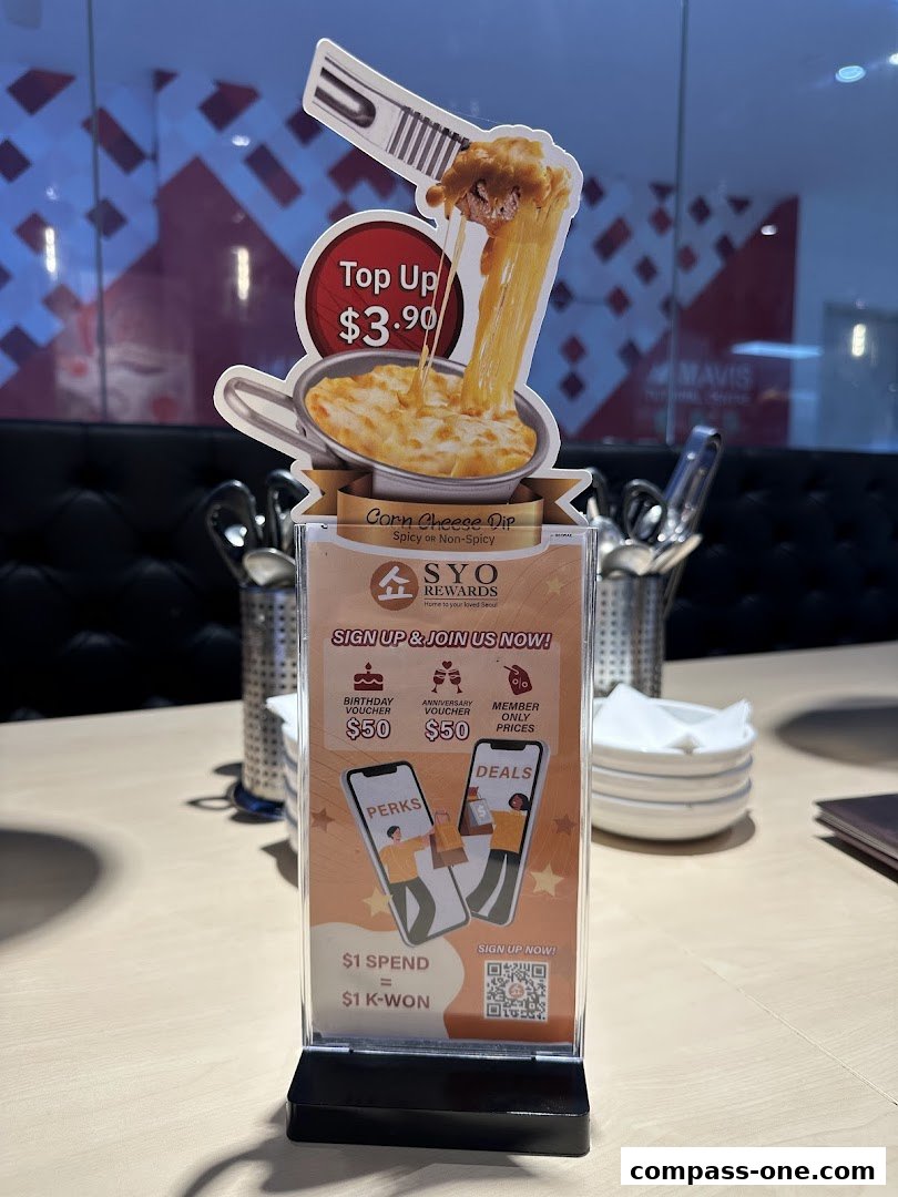 A promotional sign for a corn cheese dip with a loyalty program offer.
