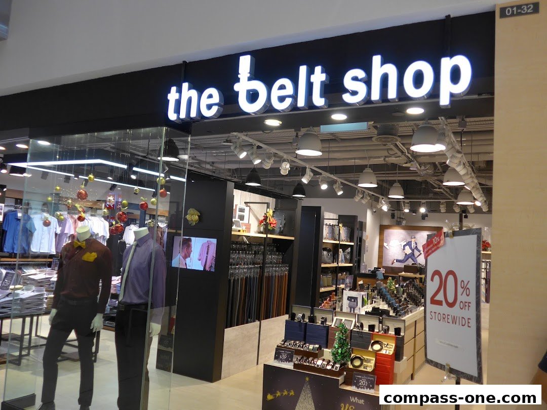 The exterior of 'the belt shop' featuring mannequins and a 20% off storewide sale sign.