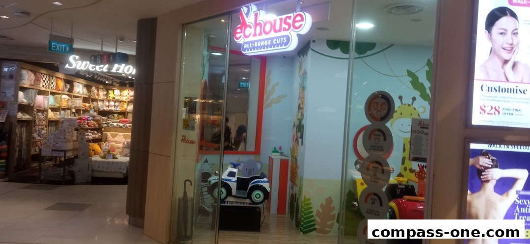 The exterior of EC House All Range Cuts, a children's hair salon, with playful decor and a waiting area.