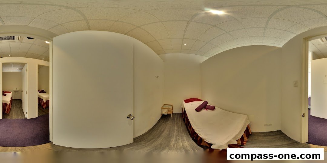 Interior view of a spa with massage beds and treatment rooms.
