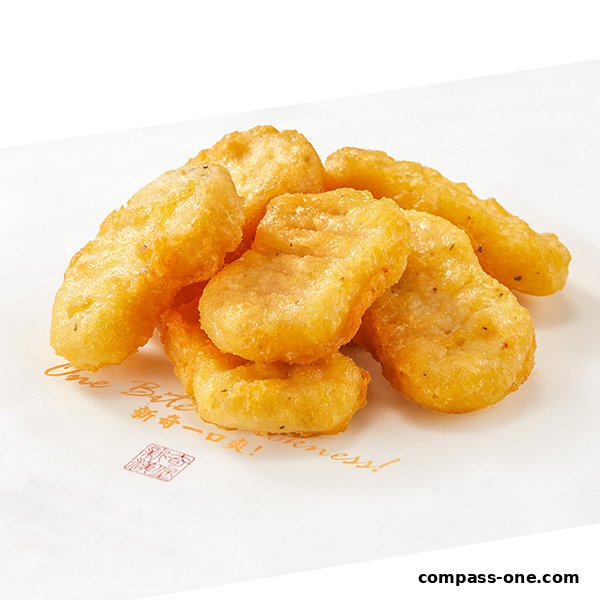 A pile of golden-brown, crispy chicken nuggets on white paper with text.
