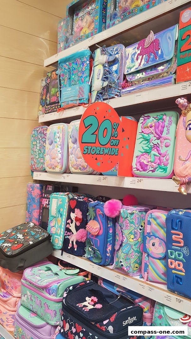 Shelves filled with colorful Smiggle pencil cases and lunch bags, featuring unicorns and mermaids.