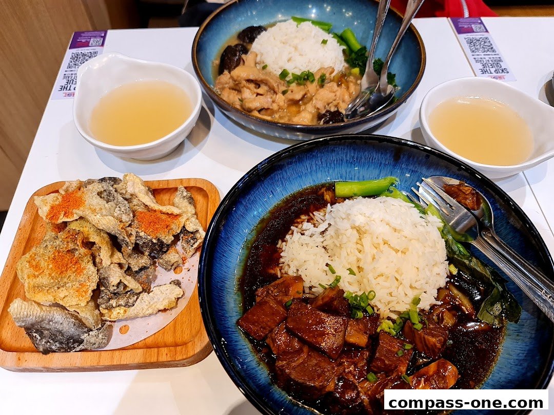 Two bowls of rice with meat and vegetables, and a side of crispy fish skin.