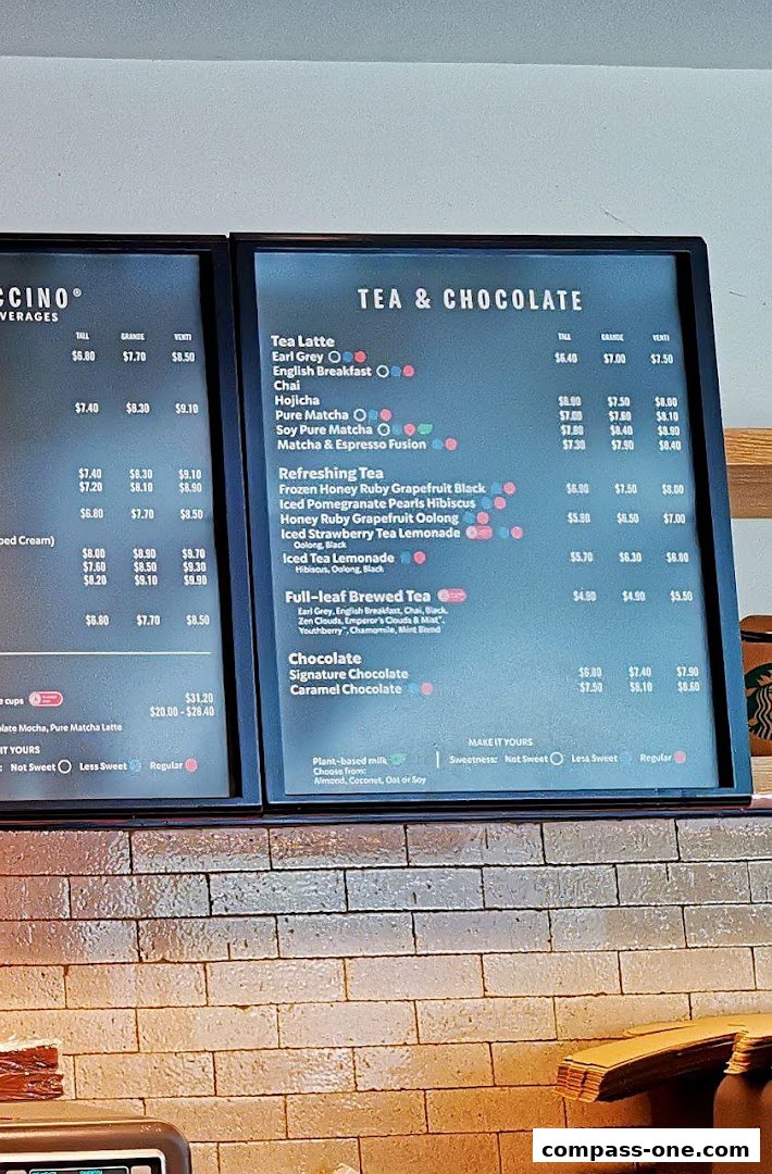 A menu board displaying various tea and chocolate beverages with their prices.