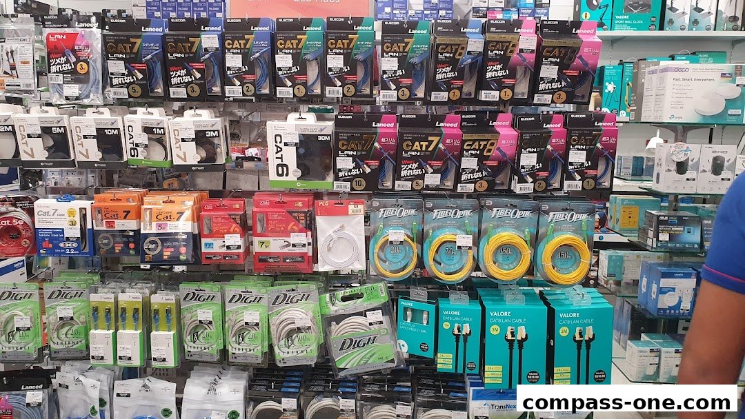 A wide selection of network cables, including Cat 7, Cat 8, and fiber optic cables, neatly displayed on shelves.