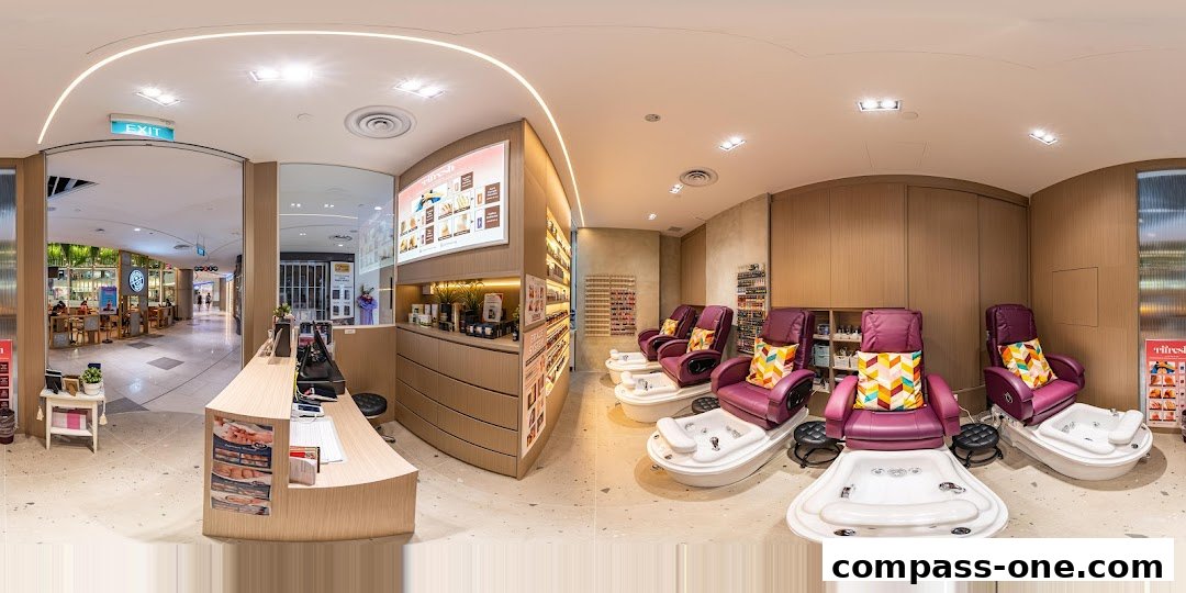 Interior of a nail spa with pedicure chairs, nail polish displays, and a reception desk.