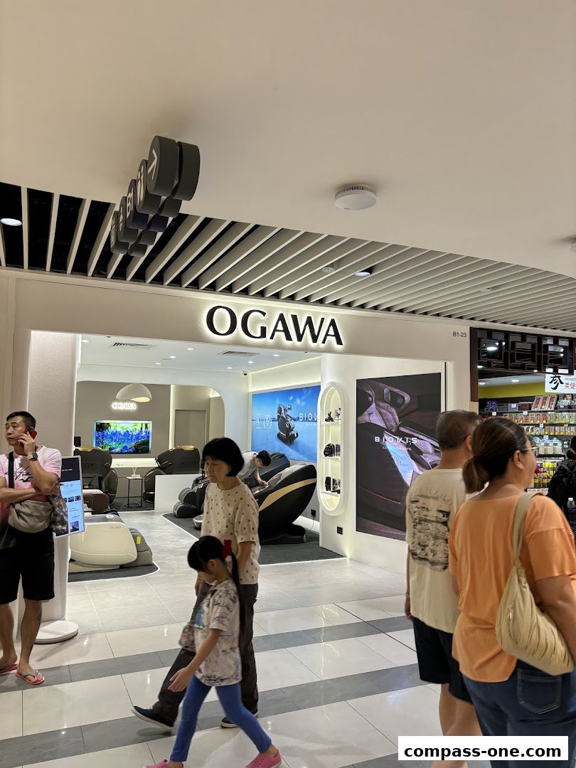OGAWA store interior with massage chairs and people browsing.