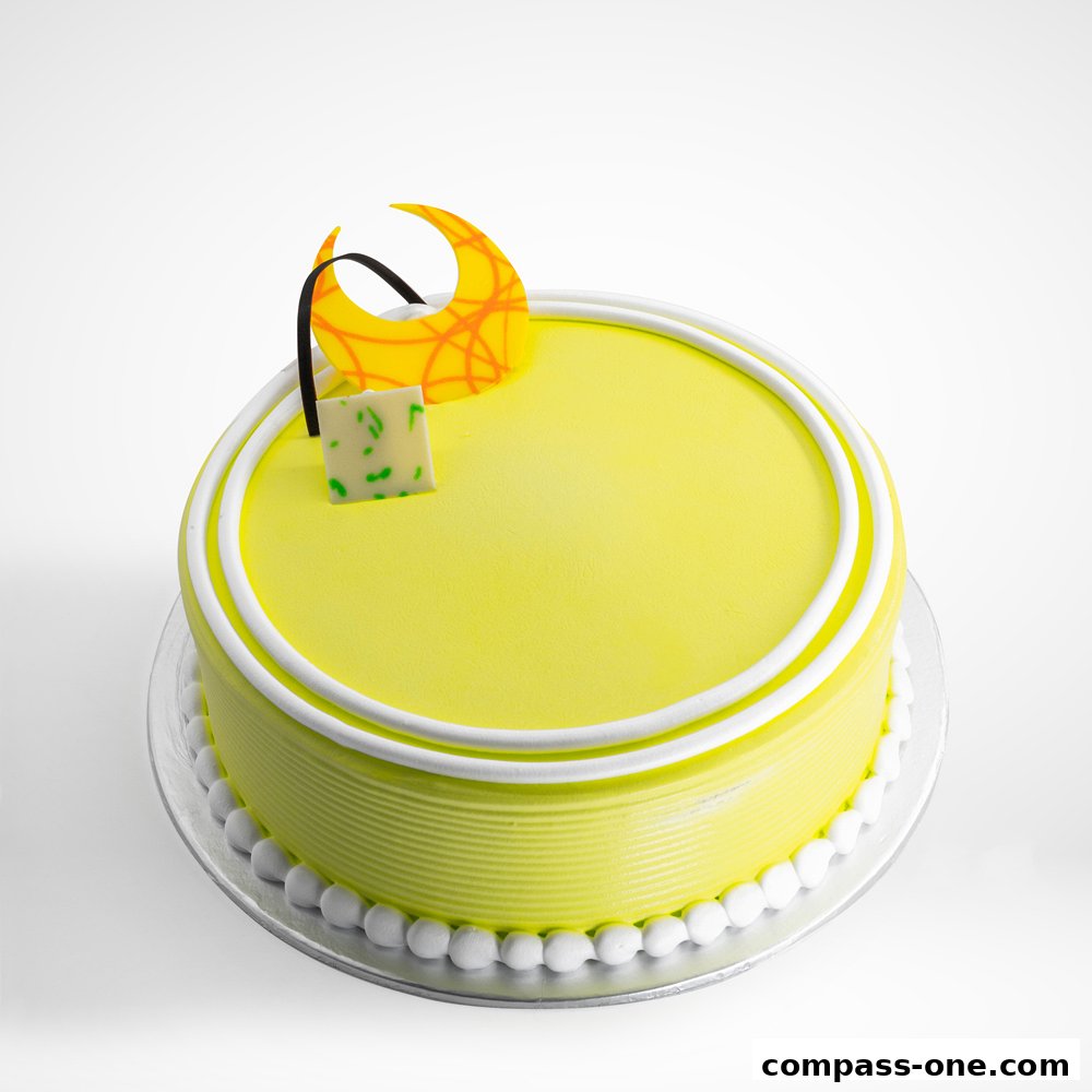 A beautifully decorated yellow cake with white frosting and a decorative crescent moon.
