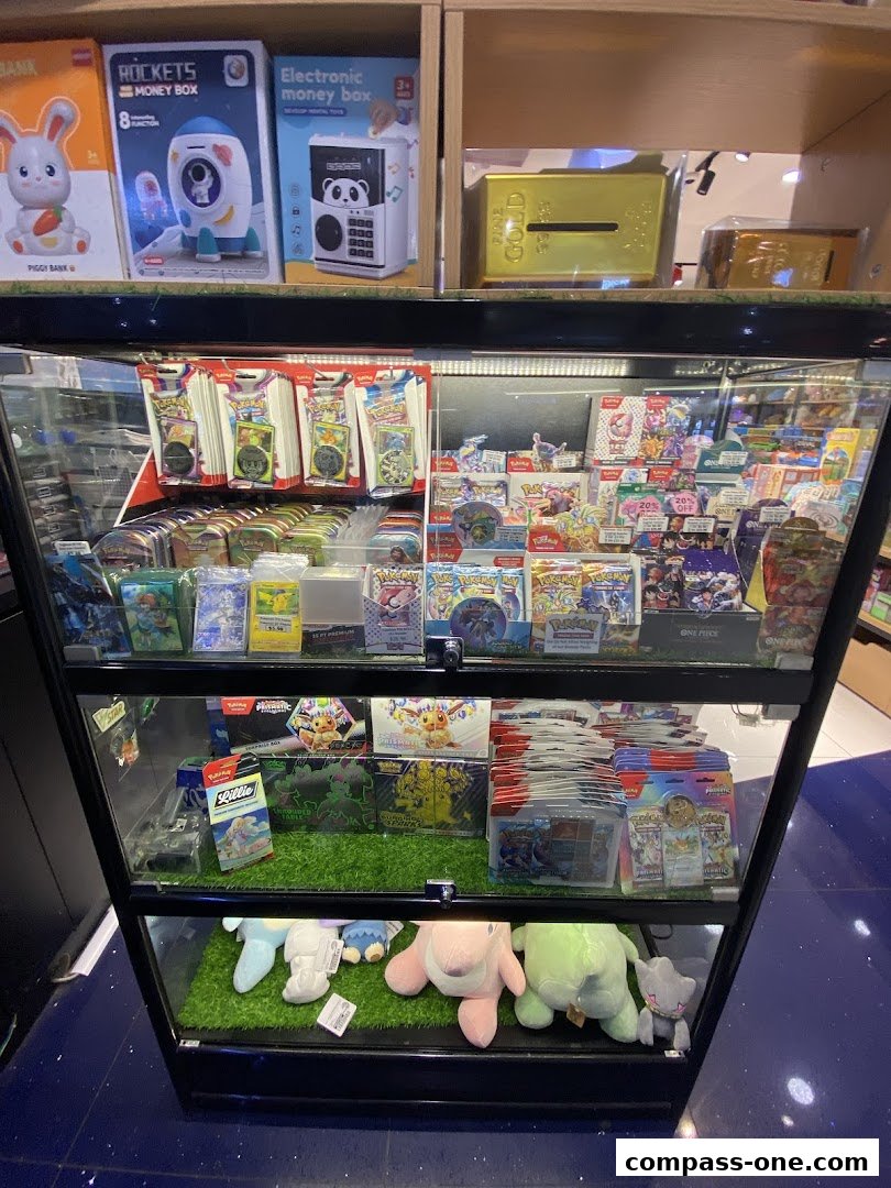 Display case filled with trading cards, money boxes, and plush toys.