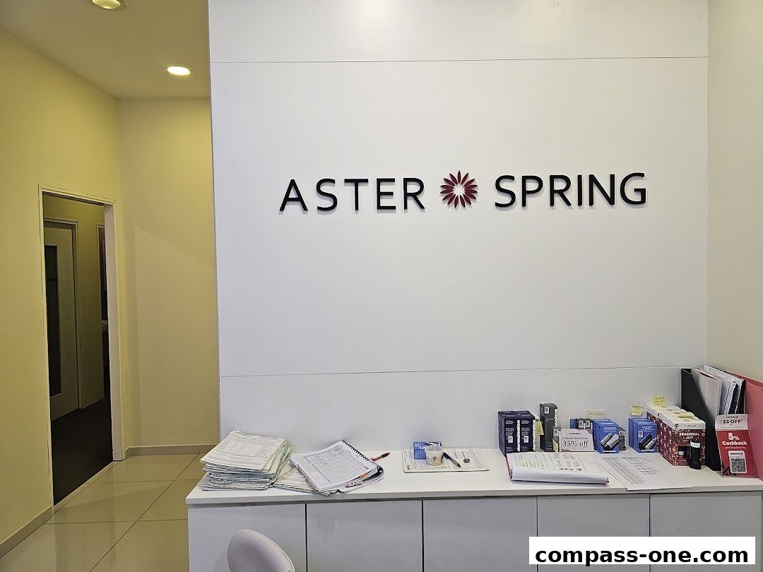 The reception area of Aster Spring with the brand name displayed prominently on the wall.