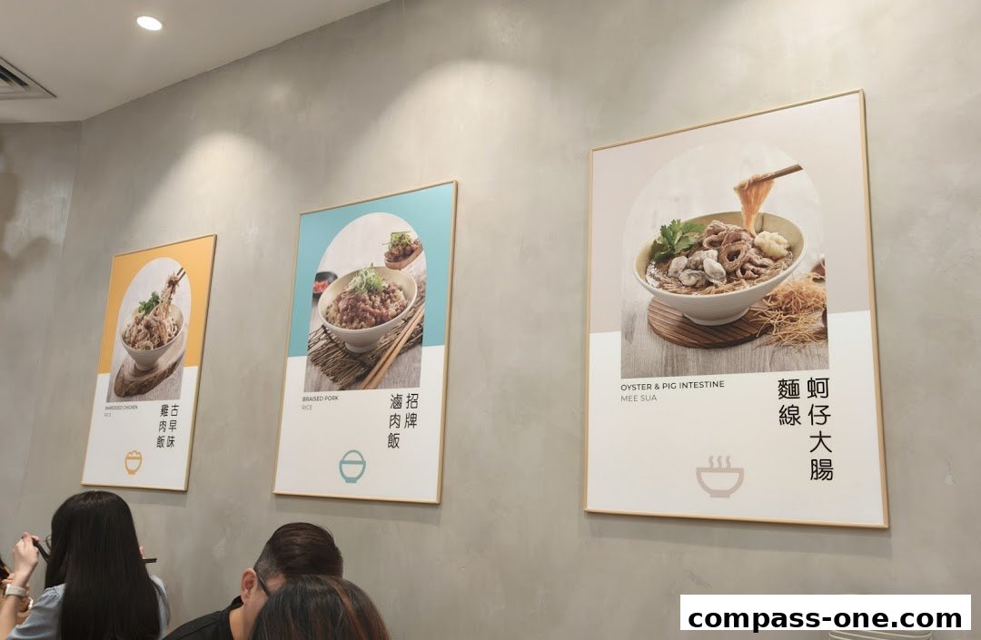Three framed posters showcasing appetizing bowls of food on a grey wall.