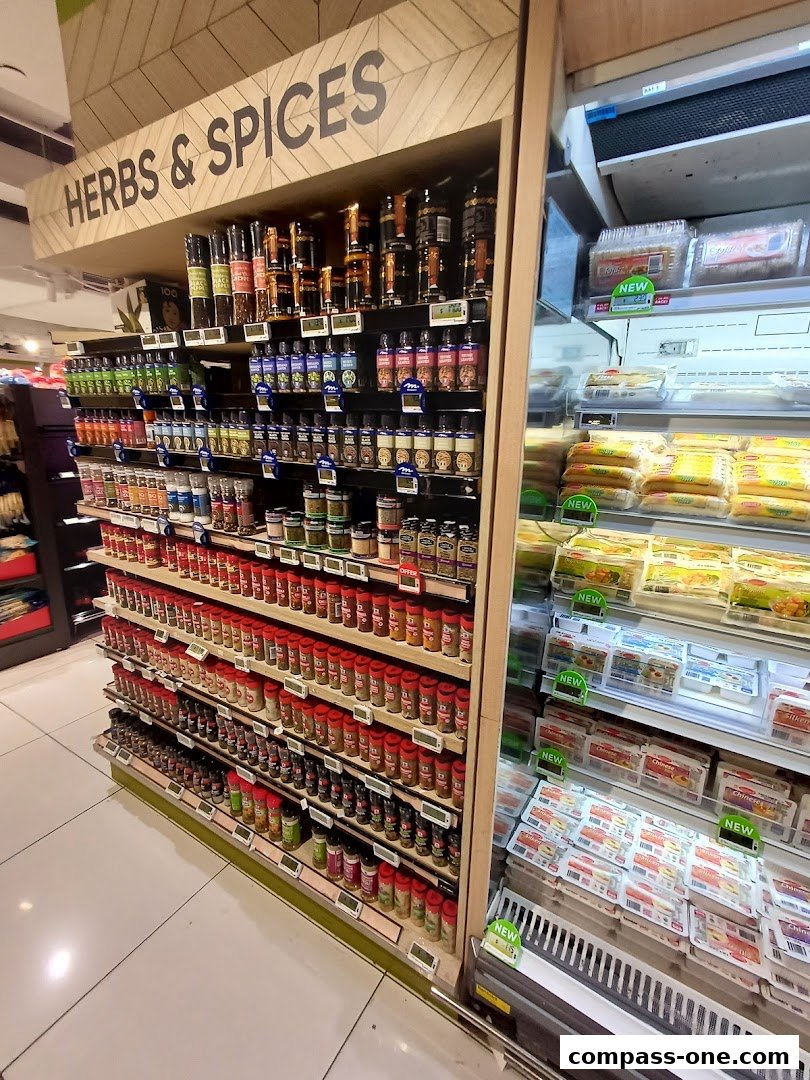 A wide selection of herbs and spices displayed on shelves, with refrigerated products on the right.