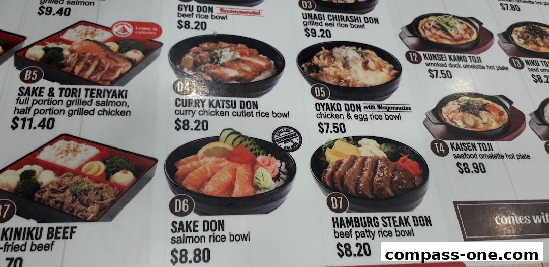 A close-up of a Japanese food menu featuring various rice bowls and hot plates.