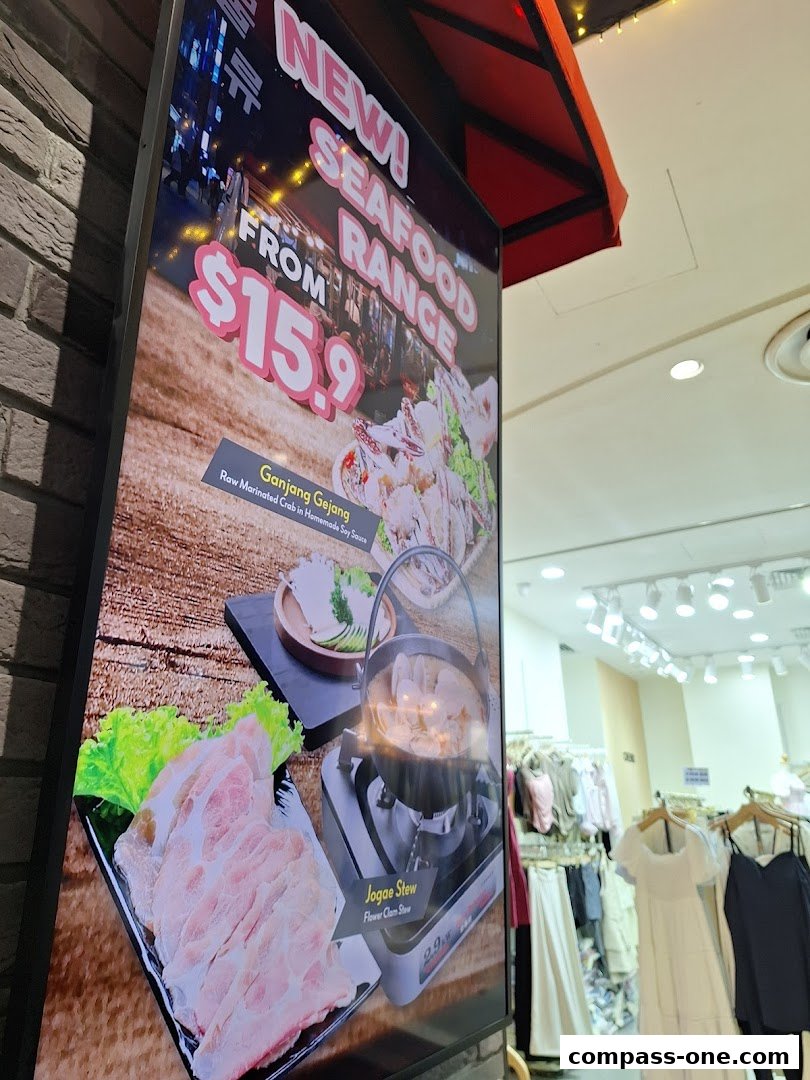 A sign advertises a new seafood range from $15.9, featuring Ganjang Gejang and Jogae Stew.