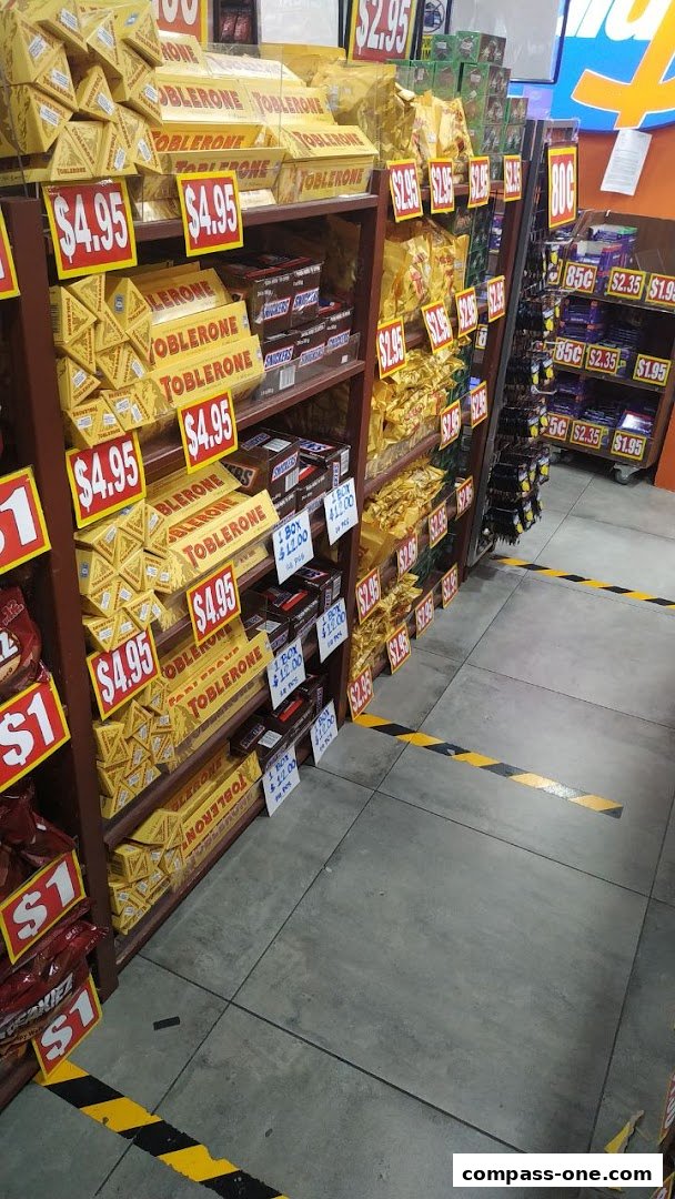 Shelves stocked with Toblerone chocolate bars and other snacks, with price tags displayed.