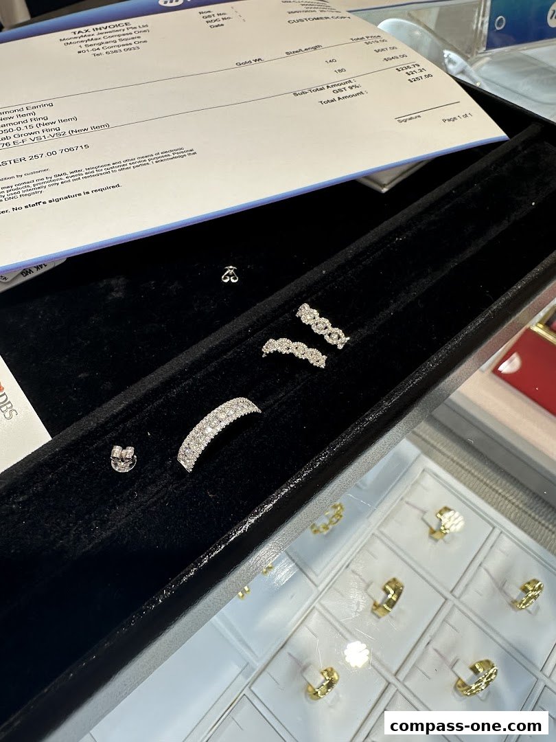 A display of diamond jewelry, including earrings and rings, with a tax invoice in the background.