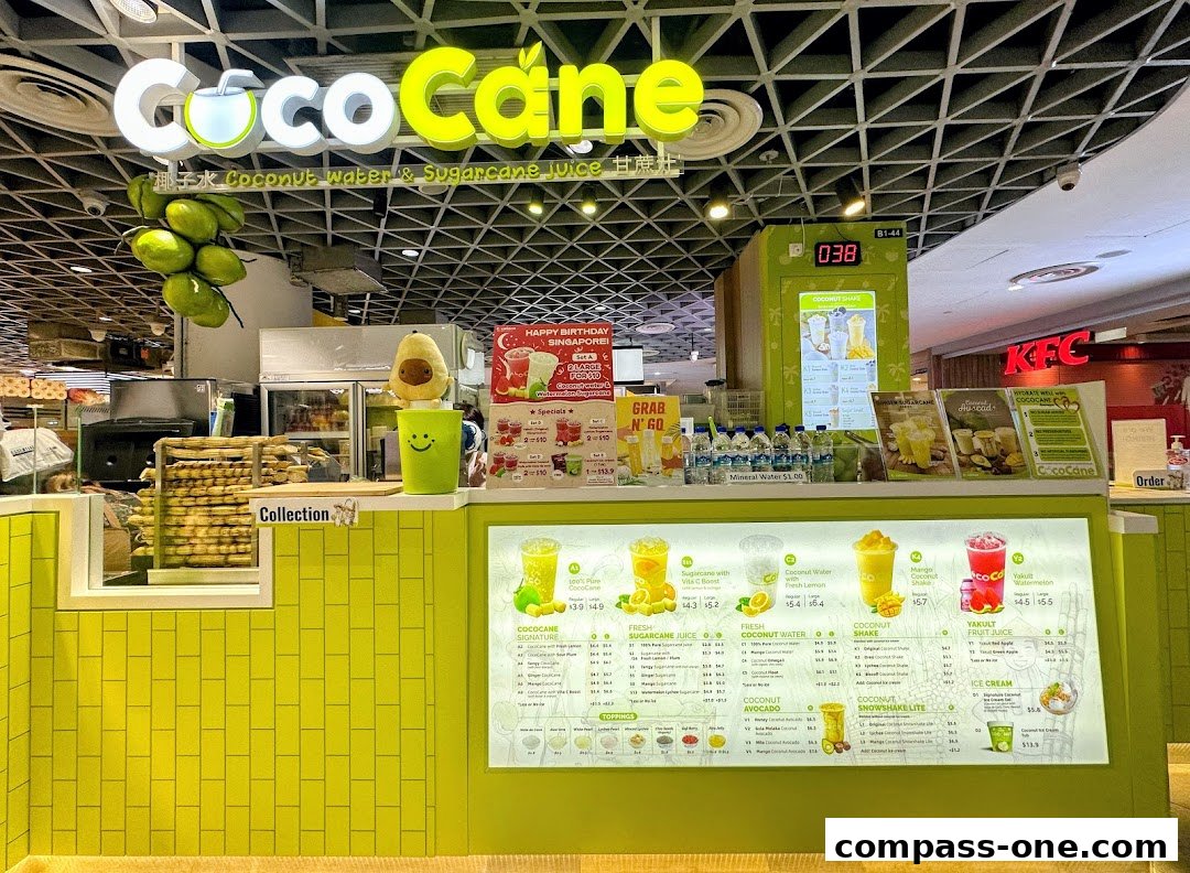 A brightly lit counter displaying a menu of coconut water and sugarcane juice drinks.