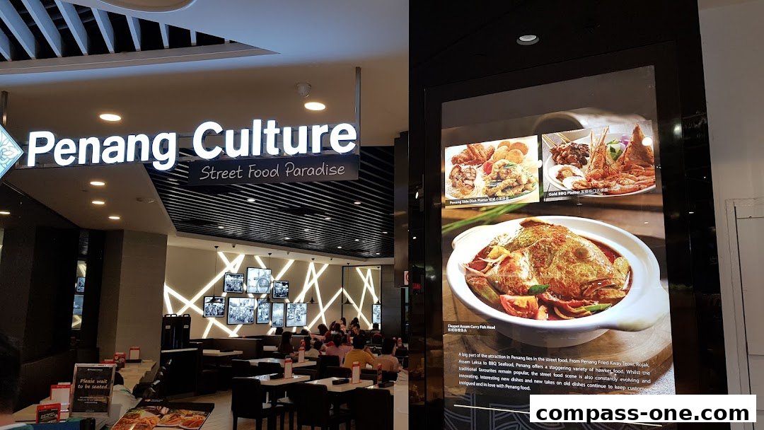 The interior of Penang Culture restaurant with a prominent sign and food displays.