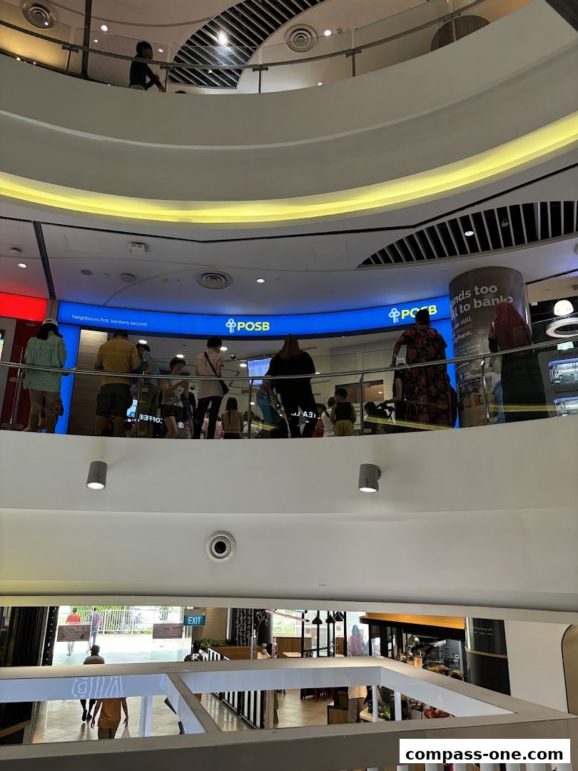 People are seen at the POSB bank branch on the second level of a mall.