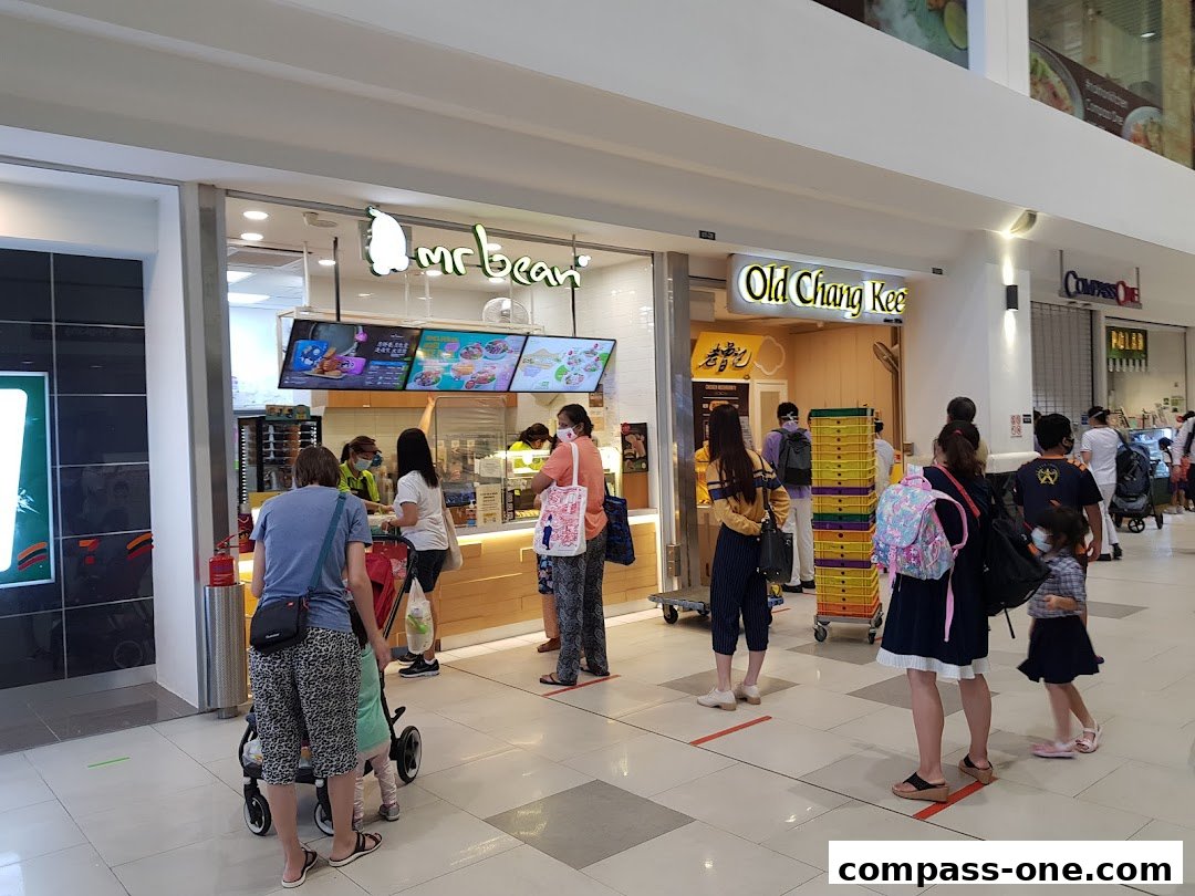 People queuing at the Mr Bean and Old Chang Kee food stalls in a shopping mall.